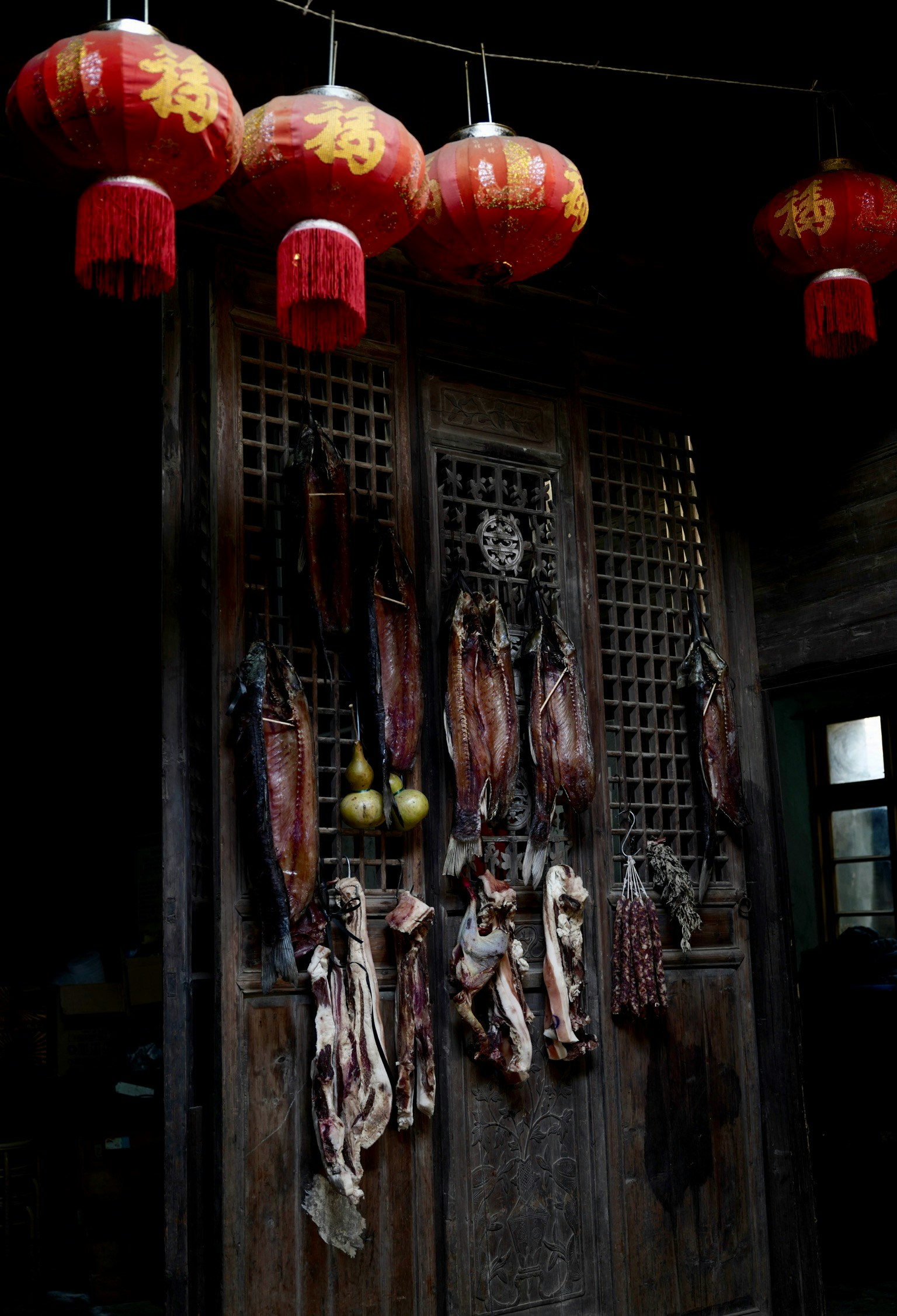 an old wooden building has lantern style lights on the outside