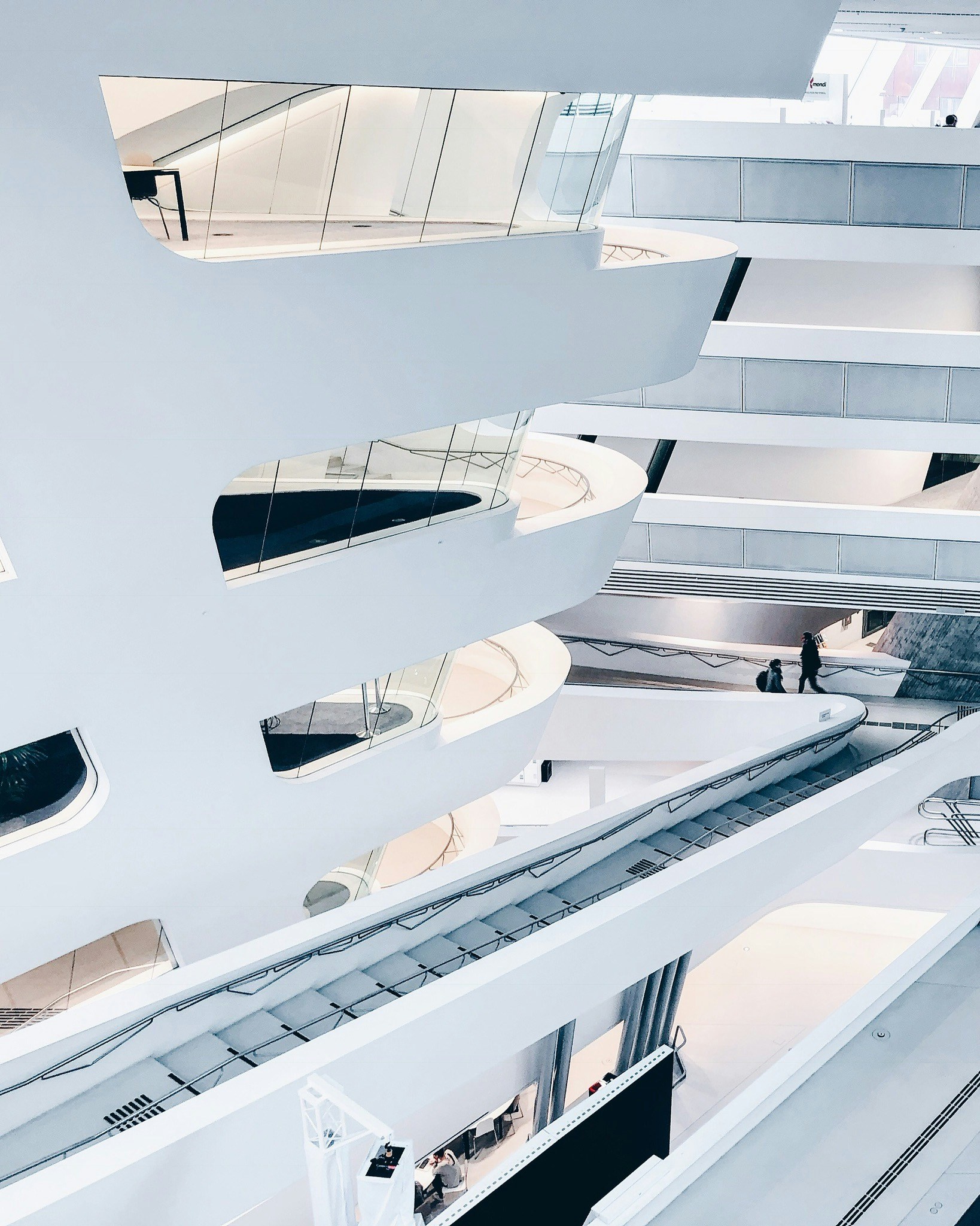 a white building that has a very big mirror ceiling