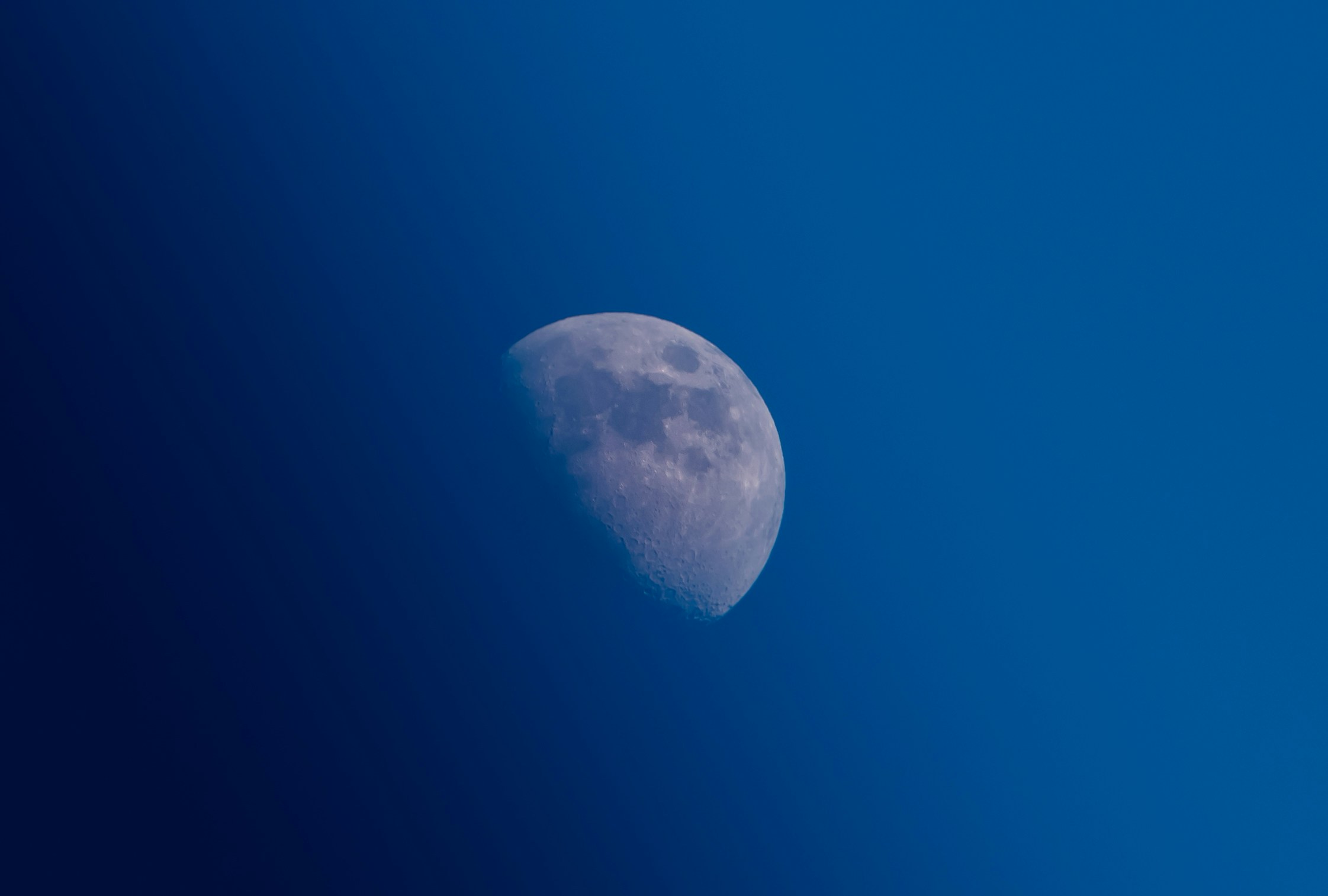 a view of the moon as it is almost dark