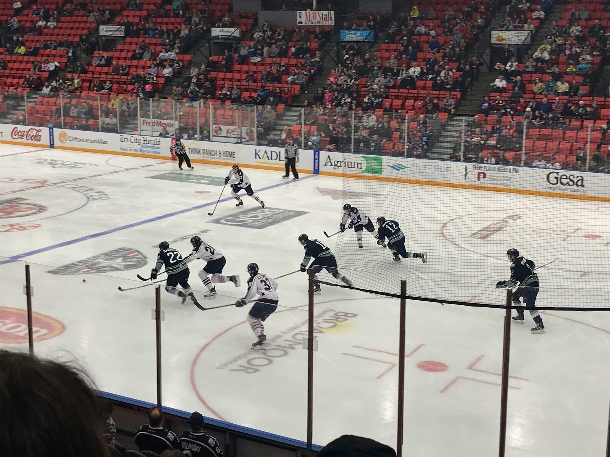 an ice hockey game is being played on the rink