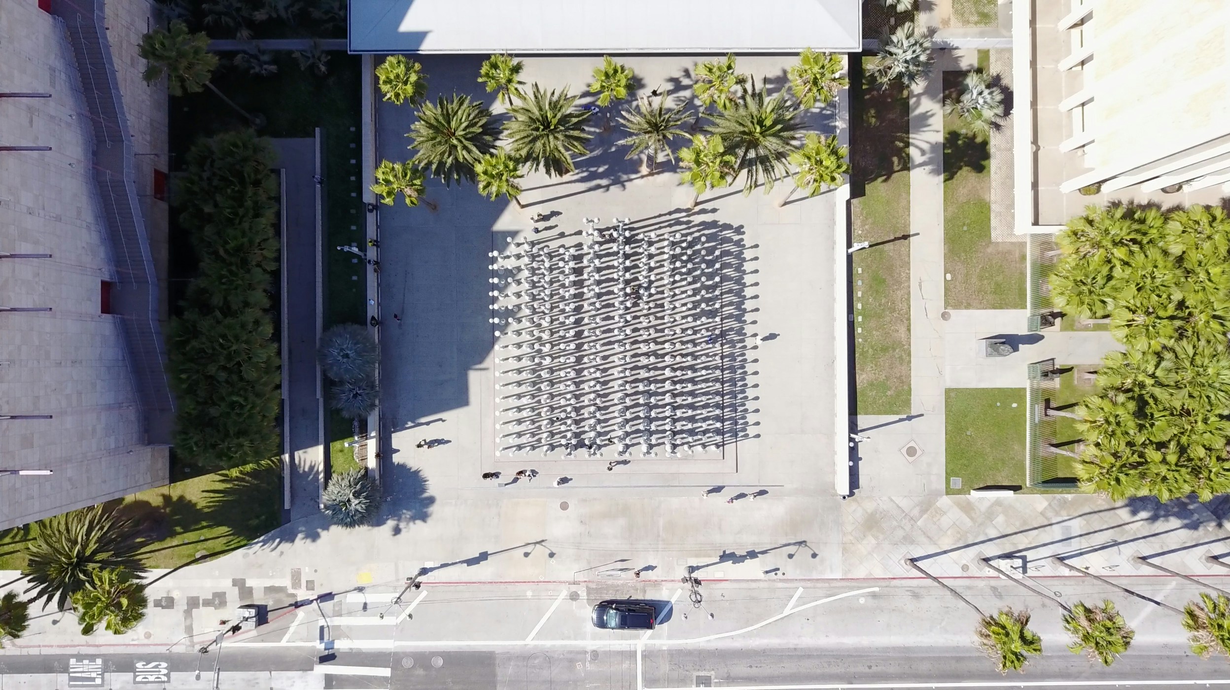 an overhead s of parking lots next to palm trees