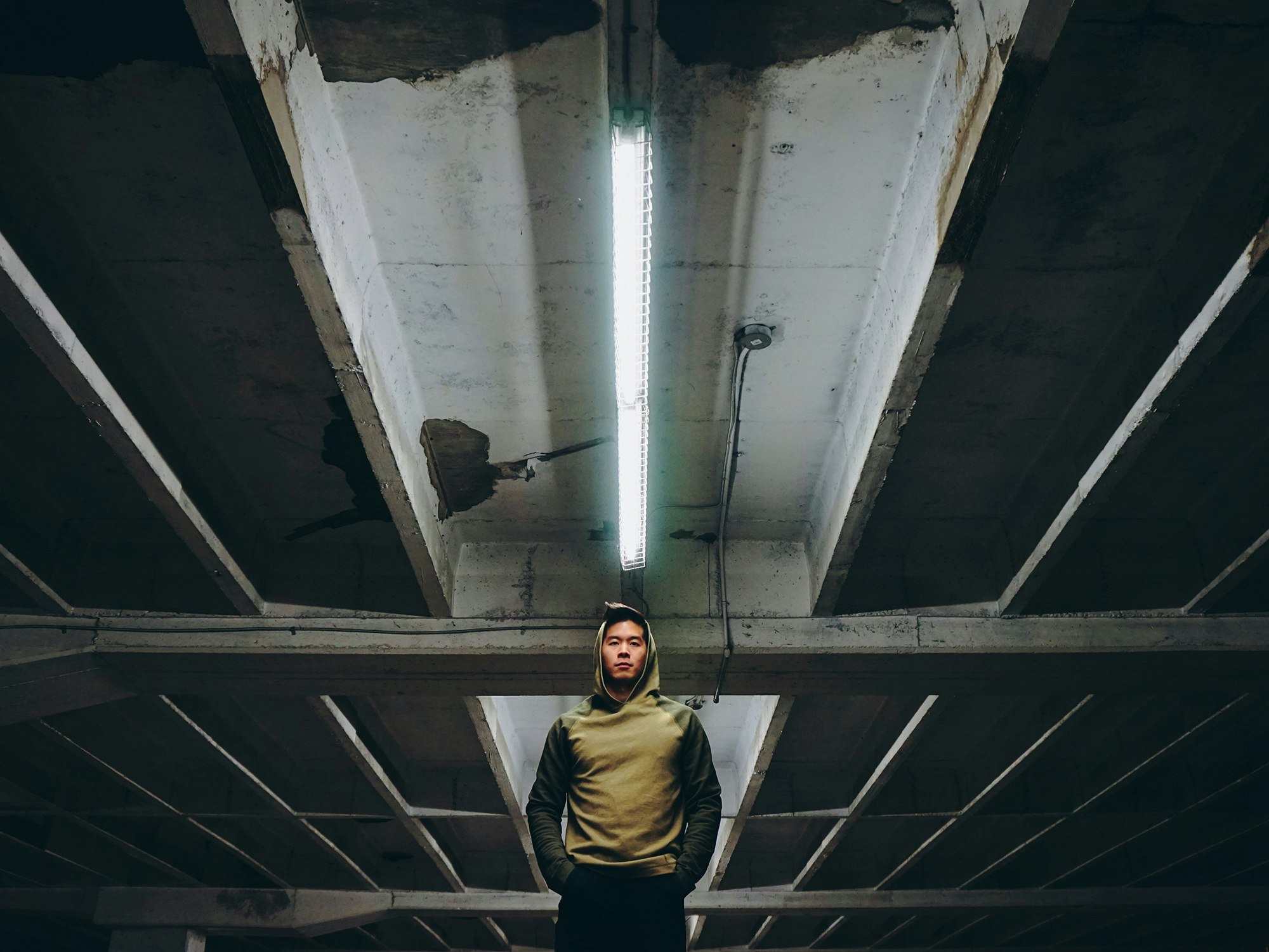 a man standing in an empty parking garage