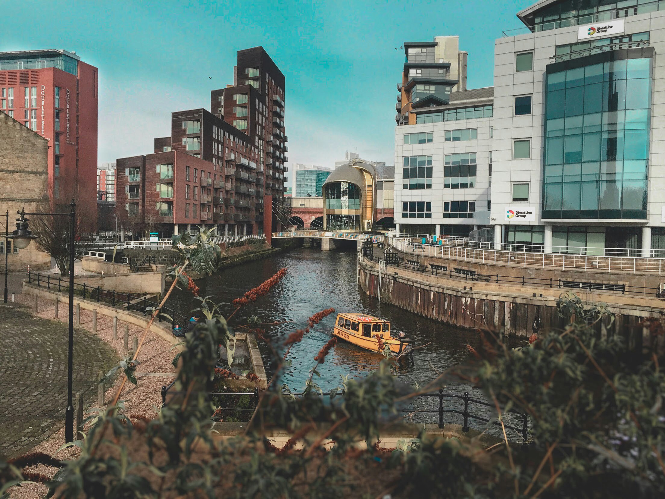 city buildings near a river in the middle of a town