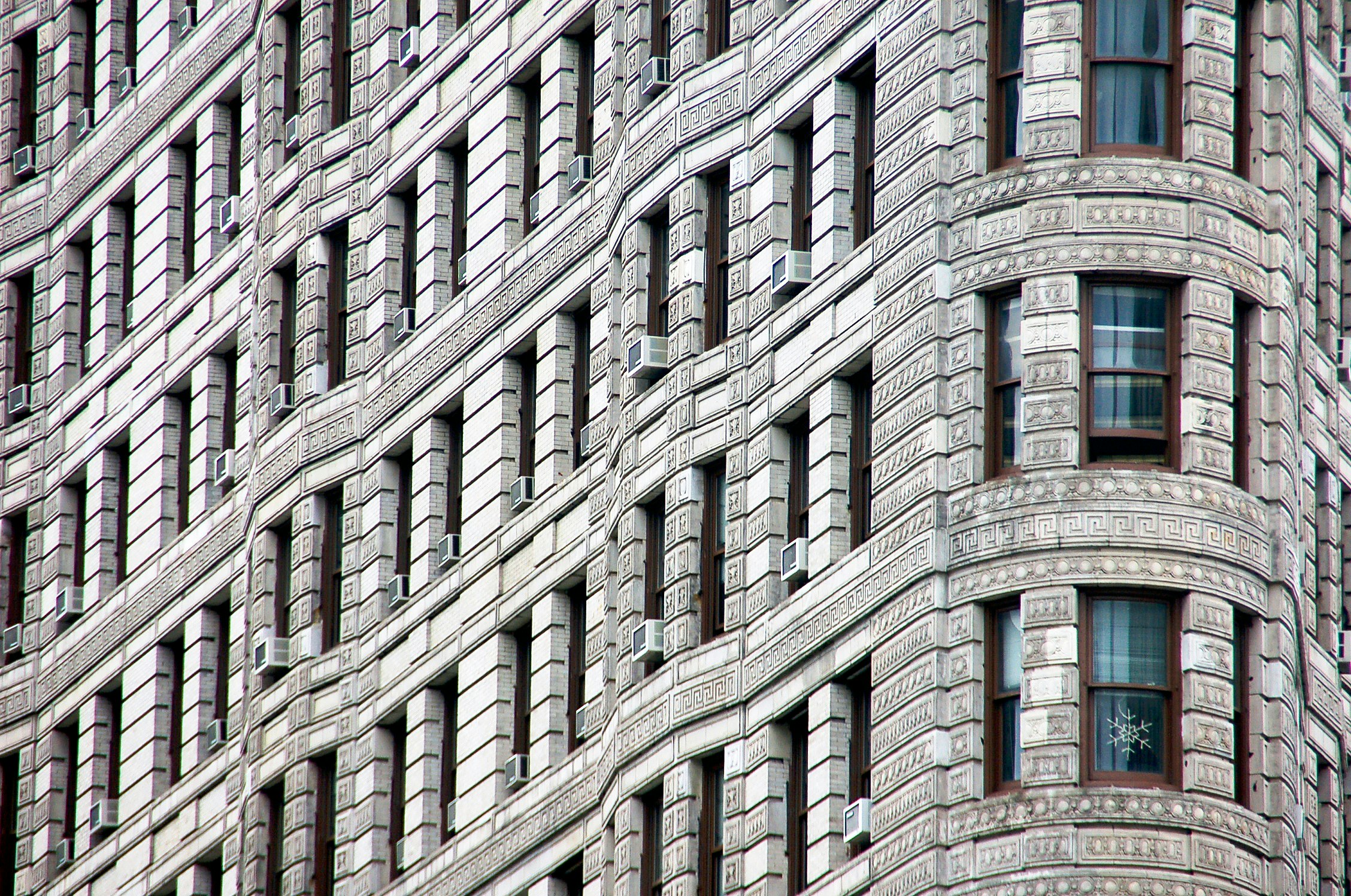 the brick and glass building is next to another building