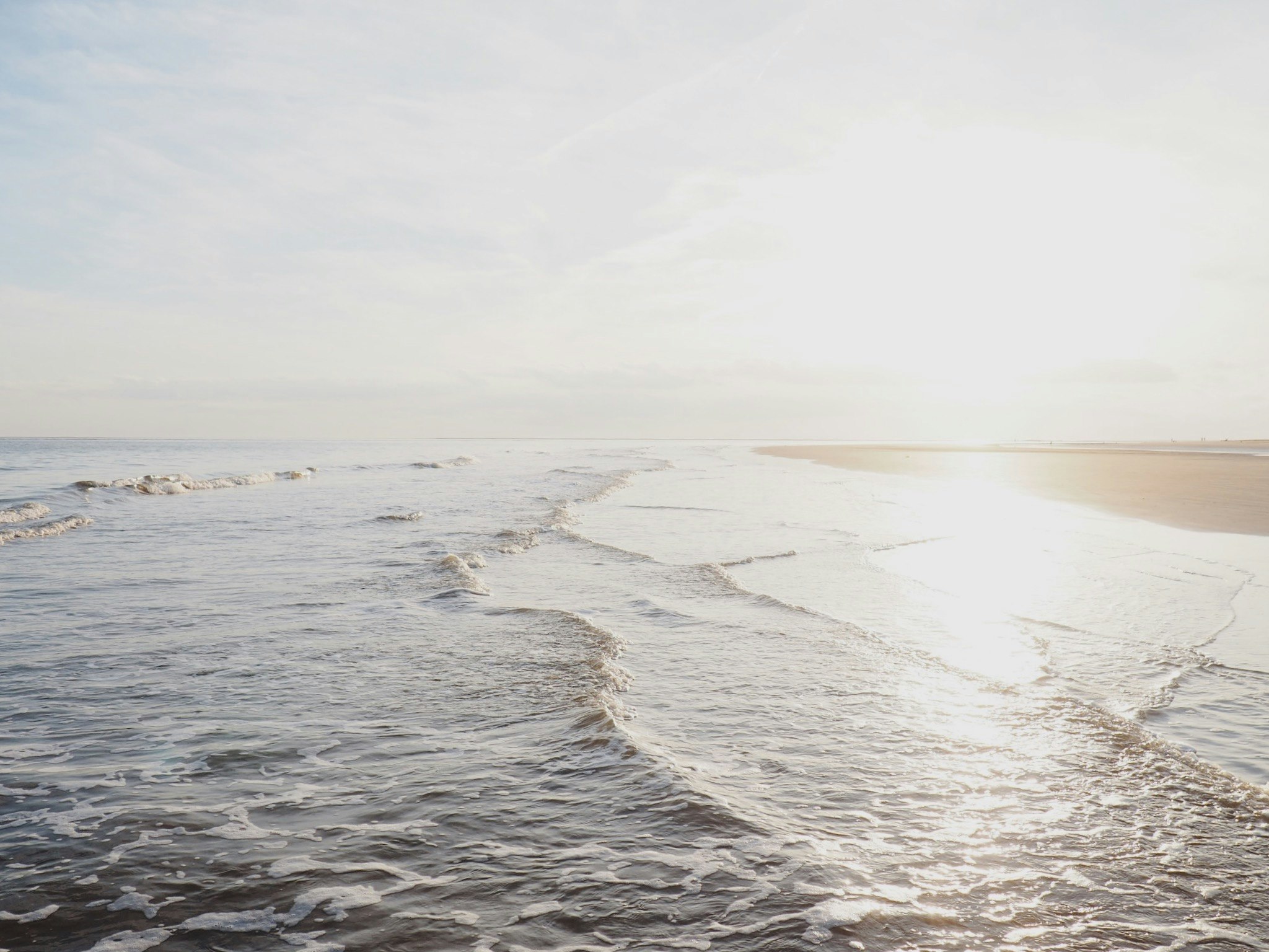 the sun shines bright in front of a beach